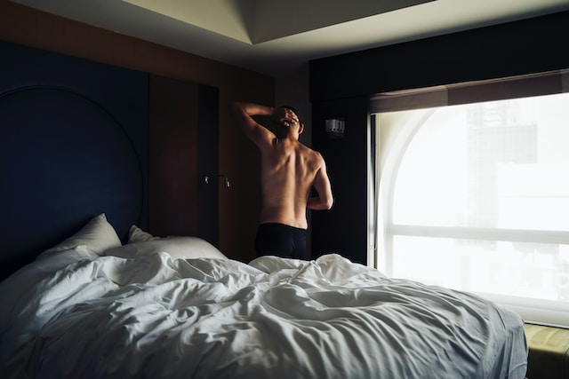 alt="A Man waking up in Andrew Huberman's Morning Routine"